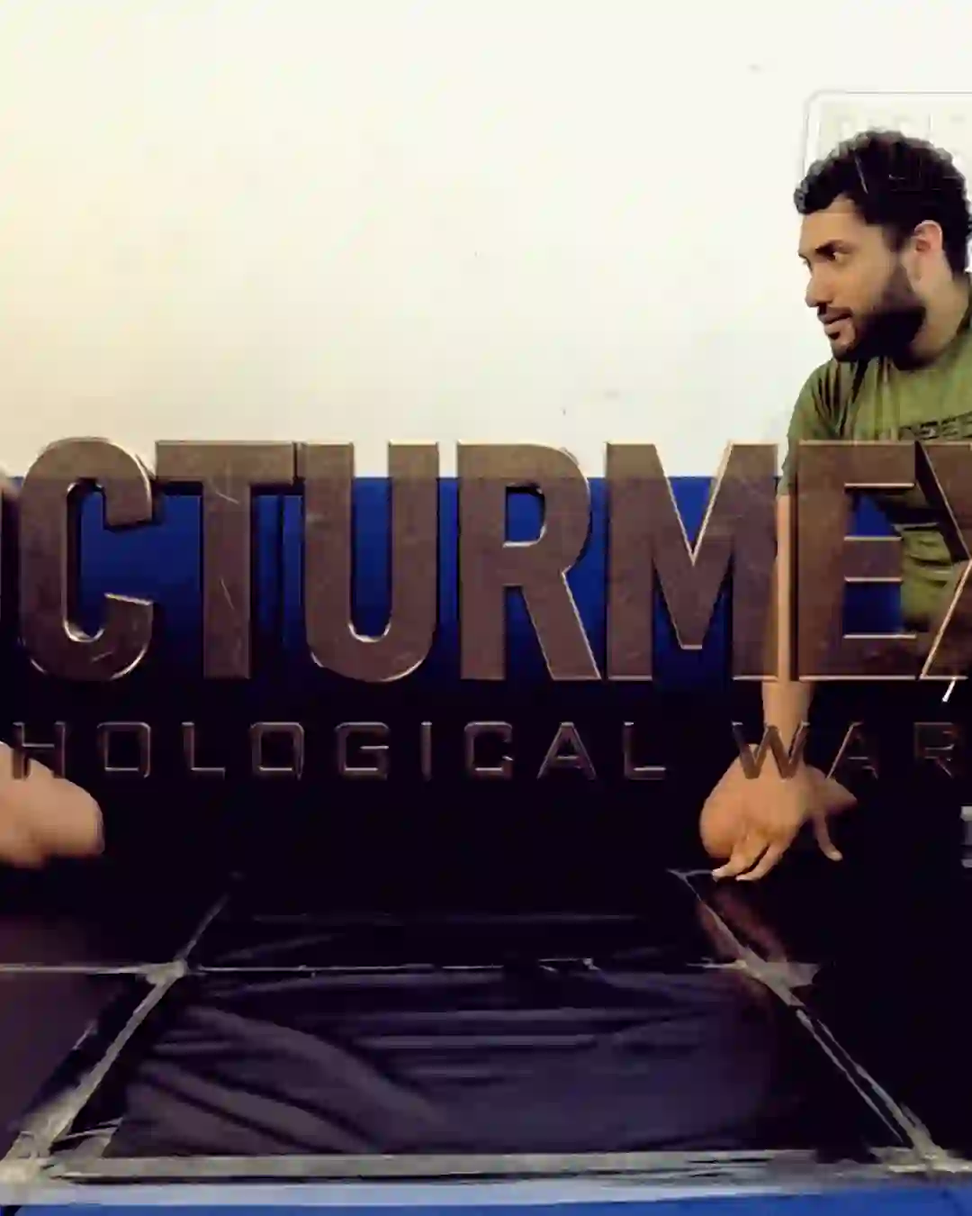Nocturmex holding top control in Nocturmex V, face blank, offering no acknowledgement